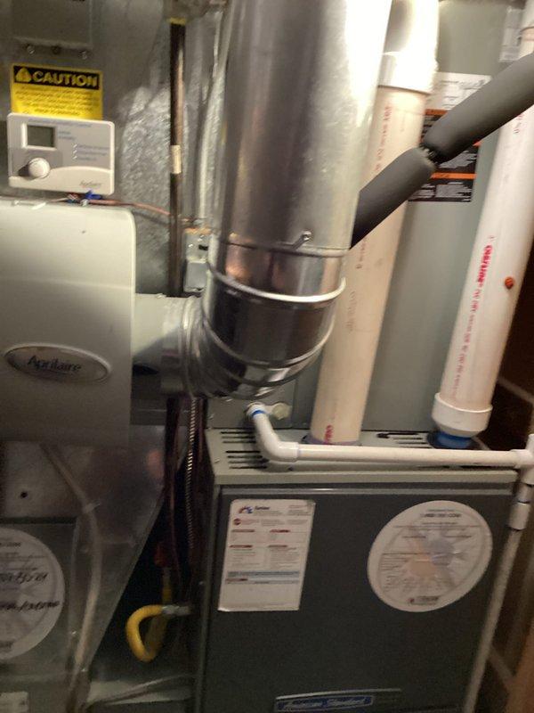 Completed routine maintenance and tune-up on residential furnace and gas fireplace system. Inspected furnace unit including heat exchanger, burner assembly, and ignition components. Verified proper operation of all safety controls and limit switches. Checked and documented combustion air intake and exhaust venting through PVC piping system. Inspected Aprilaire humidification system for proper function and water supply connections. Evaluated ductwork connections and verified secure mounting of main supply plenum. Tested blower motor operation and inspected electrical connections at unit. Performed fireplace inspection including pilot assembly, gas valve operation, and venting system integrity. Both heating systems operating within manufacturer specifications with no deficiencies noted. All equipment confirmed functional and ready for heating season operation.