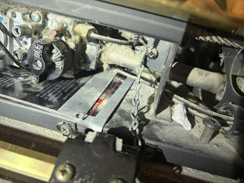 Serviced a 20+ year old Napoleon gas fireplace in the family room that would not ignite despite the pilot light being lit and the remote functioning properly. Upon inspection, found extensive dust and lint accumulation on internal mechanical components, wiring connections, and pilot assembly, which was preventing proper operation. Identified the need for a replacement pilot assembly 2-way NG component to restore full functionality to the unit.