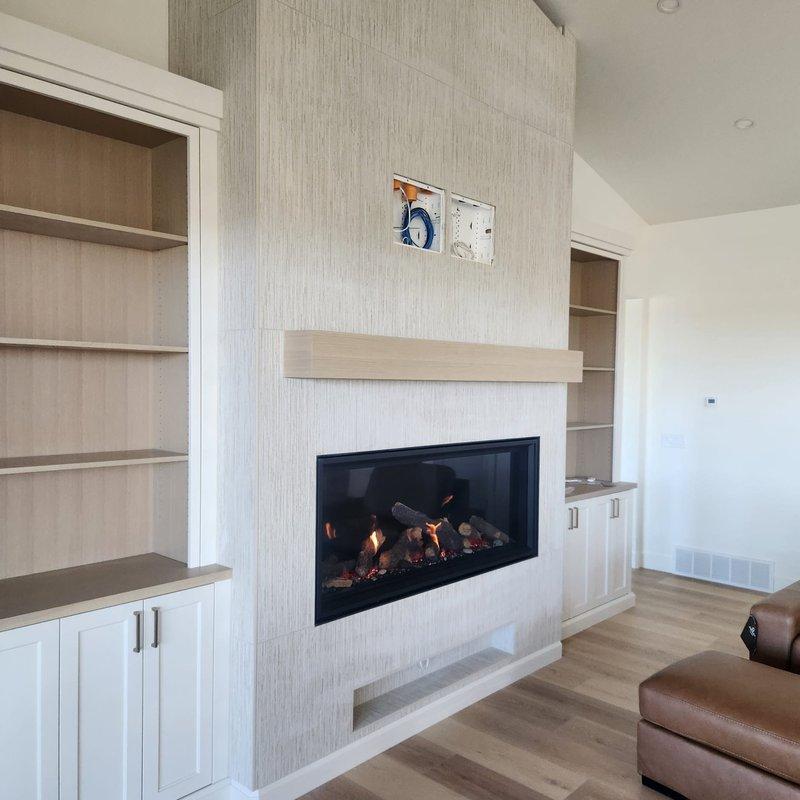 Completed clean and start service on modern horizontal gas fireplace with artificial log set. Performed thorough cleaning of glass front panel, inspected burner assembly and artificial logs for proper placement, verified gas connections and flame operation. Tested thermostat and control panel functionality, confirmed proper ignition sequence and flame pattern across entire burner length. Unit is operating efficiently with appropriate flame height and color, all safety features functioning as designed.