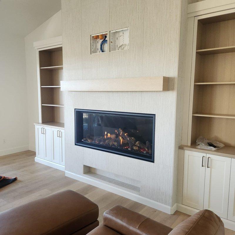 Completed clean and start service on modern horizontal gas fireplace with artificial log set. Performed thorough cleaning of glass front panel, inspected burner assembly and artificial logs for proper placement, verified gas connections and flame operation. Tested thermostat and control panel functionality, confirmed proper ignition sequence and flame pattern across entire burner length. Unit is operating efficiently with appropriate flame height and color, all safety features functioning as designed.