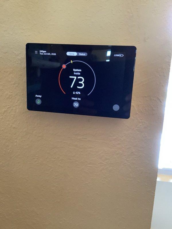 Installed Lennox iComfort S40 smart thermostat to replace existing E40 unit. Connected HVAC control wiring to new thermostat terminals, verified proper system communication, and confirmed heating operation with setpoint at 70 degrees.