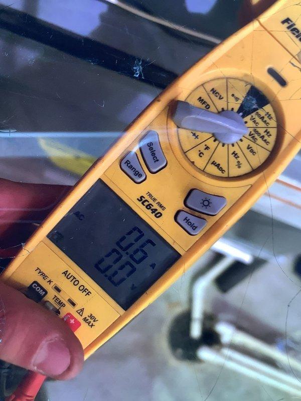 Performed diagnostic inspection and safety/performance evaluation of two furnaces (upstairs and basement units, approximately 11 years old) in response to a reported abnormal operating noise. Used a True RMS clamp multimeter to measure electrical values, including microamp DC readings for flame sensor current and AC voltage verification, to evaluate component function and ignition circuit performance.