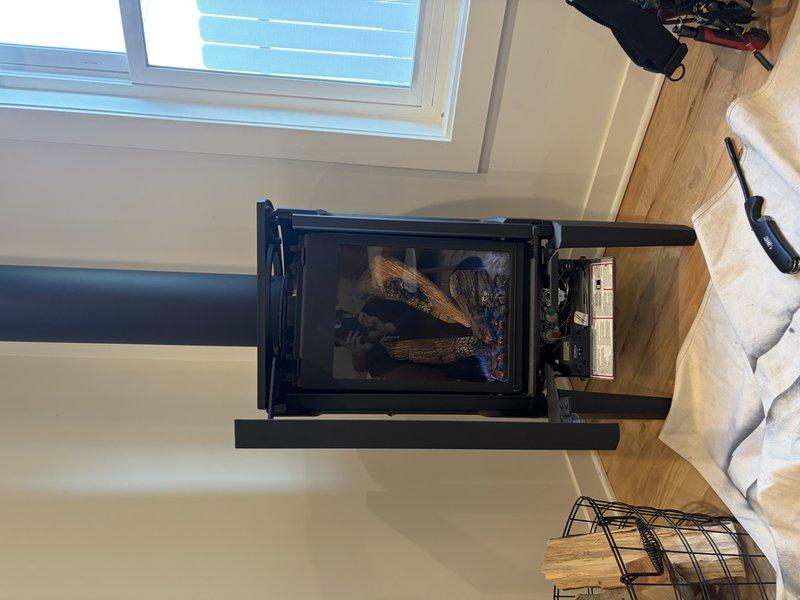 Inspected a 4-year-old gas fireplace for a reported chemical/fume-like odor during initial operation cycles. Opened the control compartment and examined the burner assembly, wiring, and mechanical components, with no visible damage, corrosion, or abnormalities observed, and verified normal flame presentation and operation of the log set and vent system. The odor is consistent with normal off-gassing of paint, binders, and residues, which typically dissipates after several burn cycles.