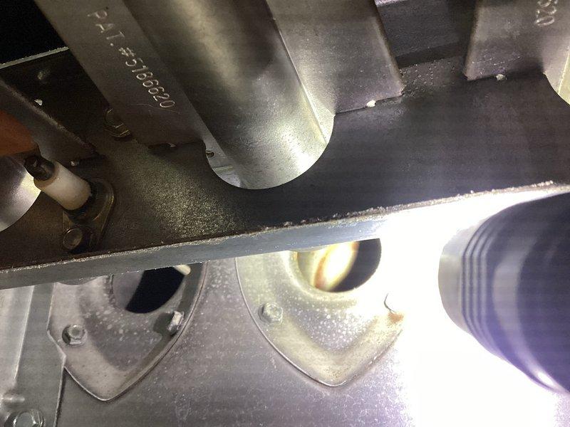 Performed scheduled heating maintenance on a single gas furnace with an attached evaporator coil cabinet. Inspected the burner compartment, igniter, burner tubes, and heat exchanger openings, and checked the blower motor, wiring, condensate drain piping, and refrigerant line insulation, with electrical readings taken using a multimeter. No operational issues were reported, and the system was left in working condition.