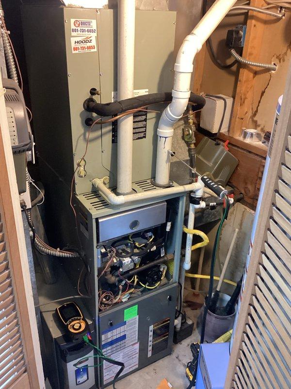 Performed scheduled heating maintenance on a single gas furnace with an attached evaporator coil cabinet. Inspected the burner compartment, igniter, burner tubes, and heat exchanger openings, and checked the blower motor, wiring, condensate drain piping, and refrigerant line insulation, with electrical readings taken using a multimeter. No operational issues were reported, and the system was left in working condition.