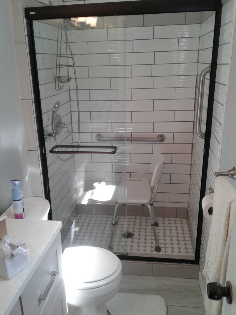 Install grab bars handheld shower sprayer and shower chair