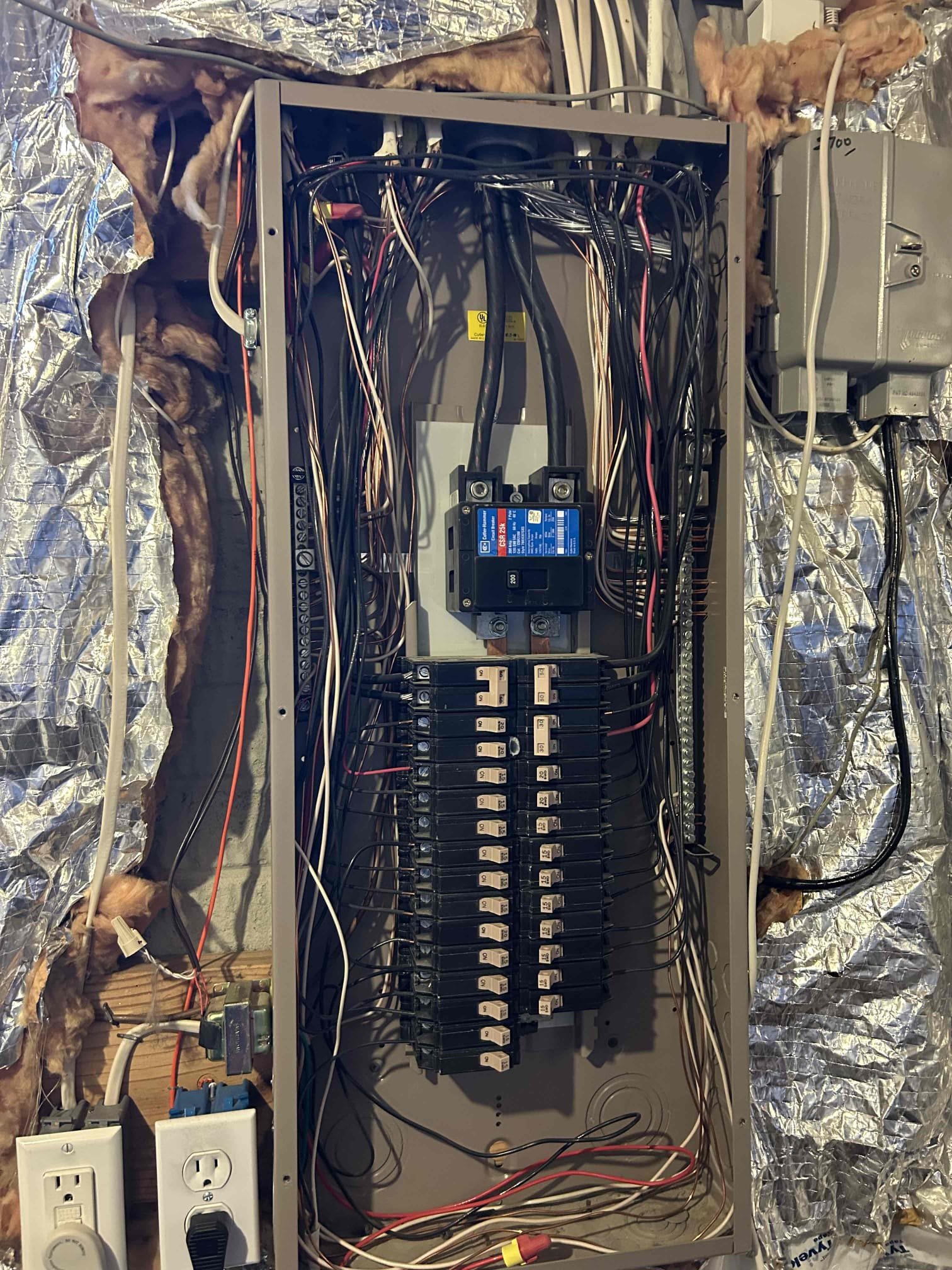Trouble shot dimming lights to find that there is a problem with the neutral wire outside of the home. When any substantial load is put on any of the circuits, one of the legs severely drops down in voltage while the other one raises.
With just the microwave, turning on the left leg and the panel at the main lugs rose to 129 V as the right one drop down to 109 V.
