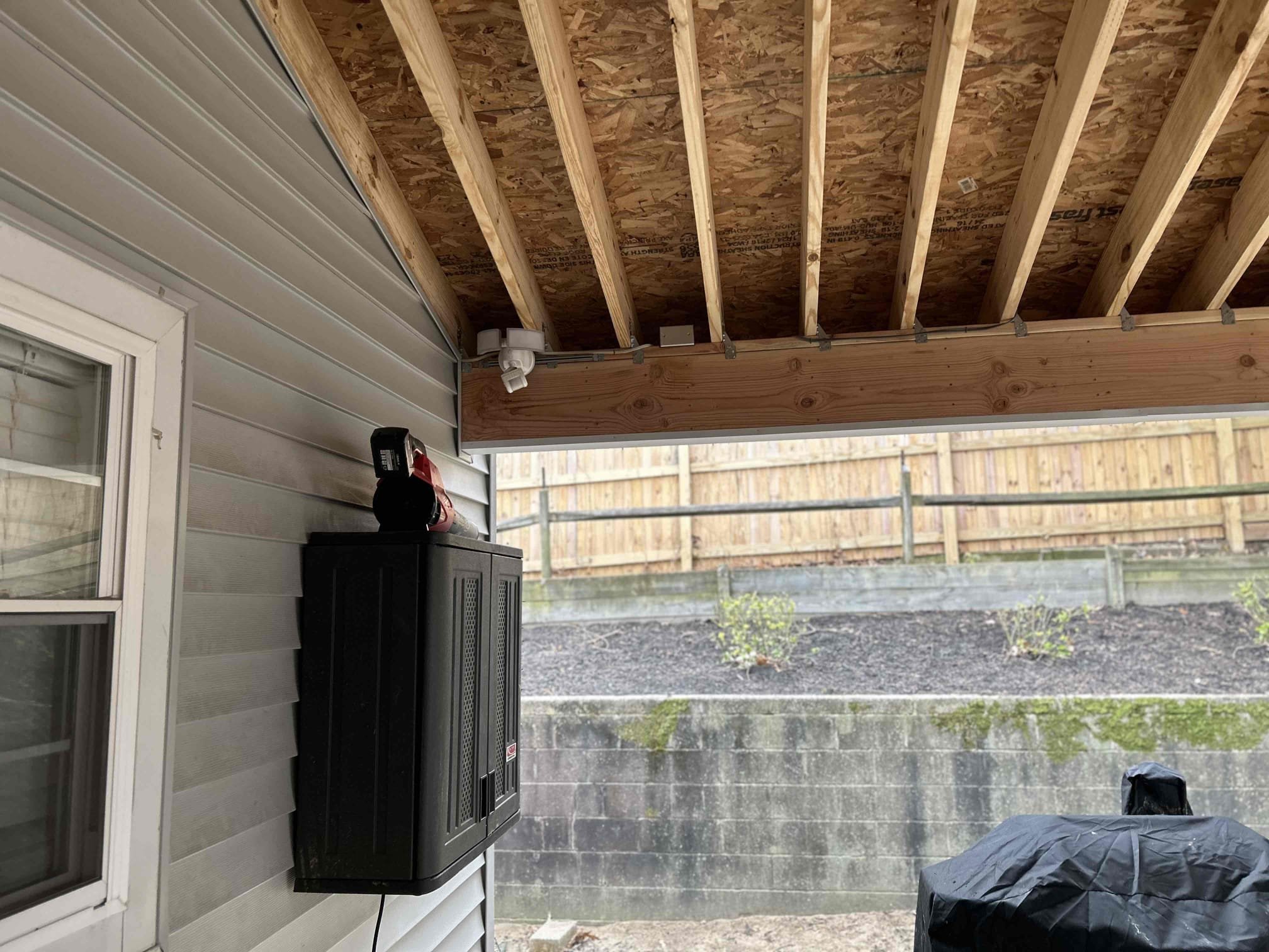 Install 2 customer supplied fans on back deck
The reason for today’s visit was to look at installing the wire back on their new deck. Customer previously had a deck with existing wiring however, when they replaced the roof, they never installed it back. The existing UF wire was in PVC up the side of the house in the back right corner where the deck starts. We ended up installing two new ceiling fan locations as well as two new receptacles. We converted the PVC over to flex and installed it into the ceiling of the deck and installed a junction box over by the security light. We ran in all wire in 12/2  UF cable.