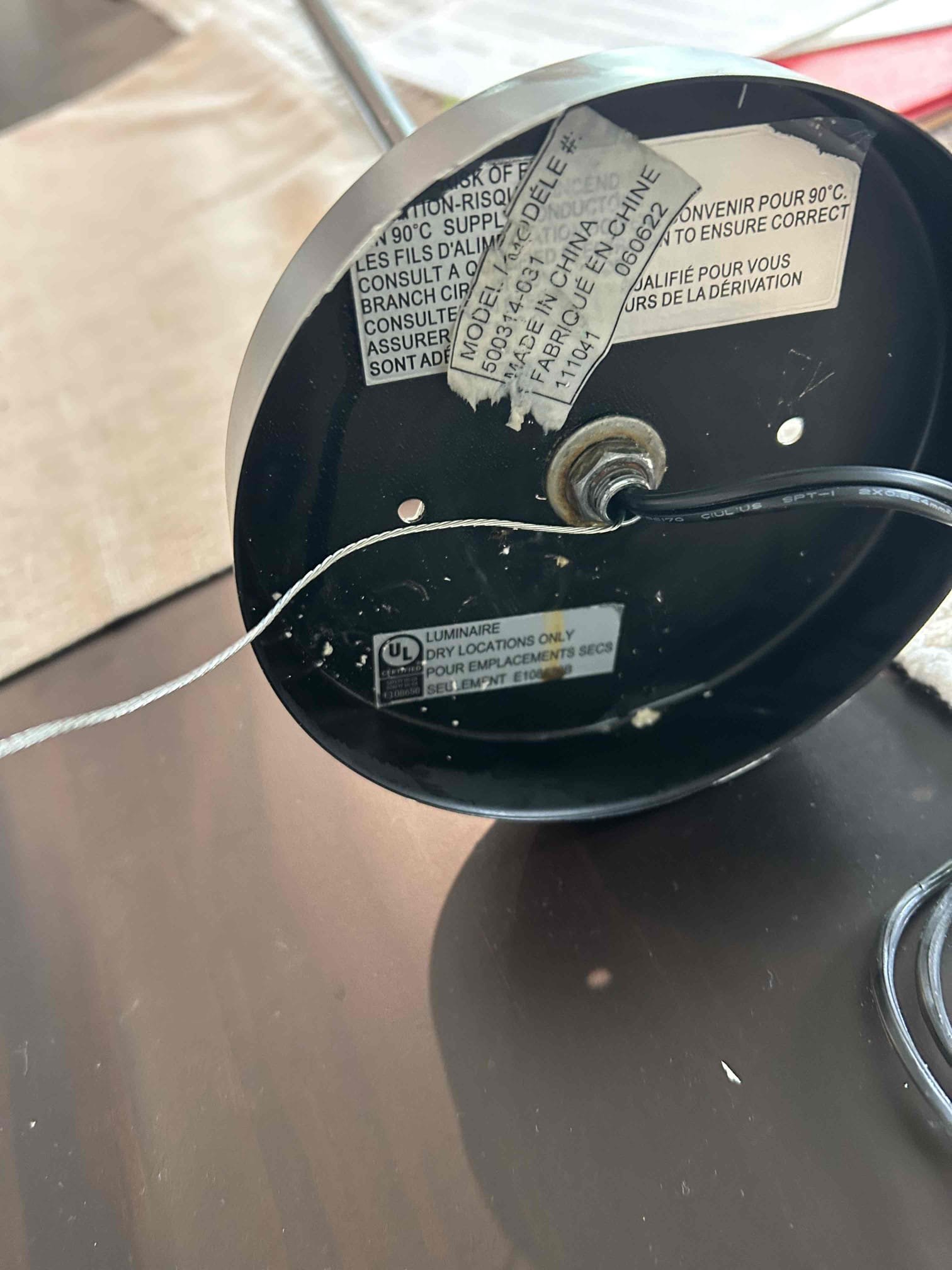 Trouble shot, tripping our fault breaker for the kitchen lights and found that there was a slow leak coming from the trap for the shower above the light fixture. This was causing water to drip down inside the light and caused it to ground out causing the breaker to trip.