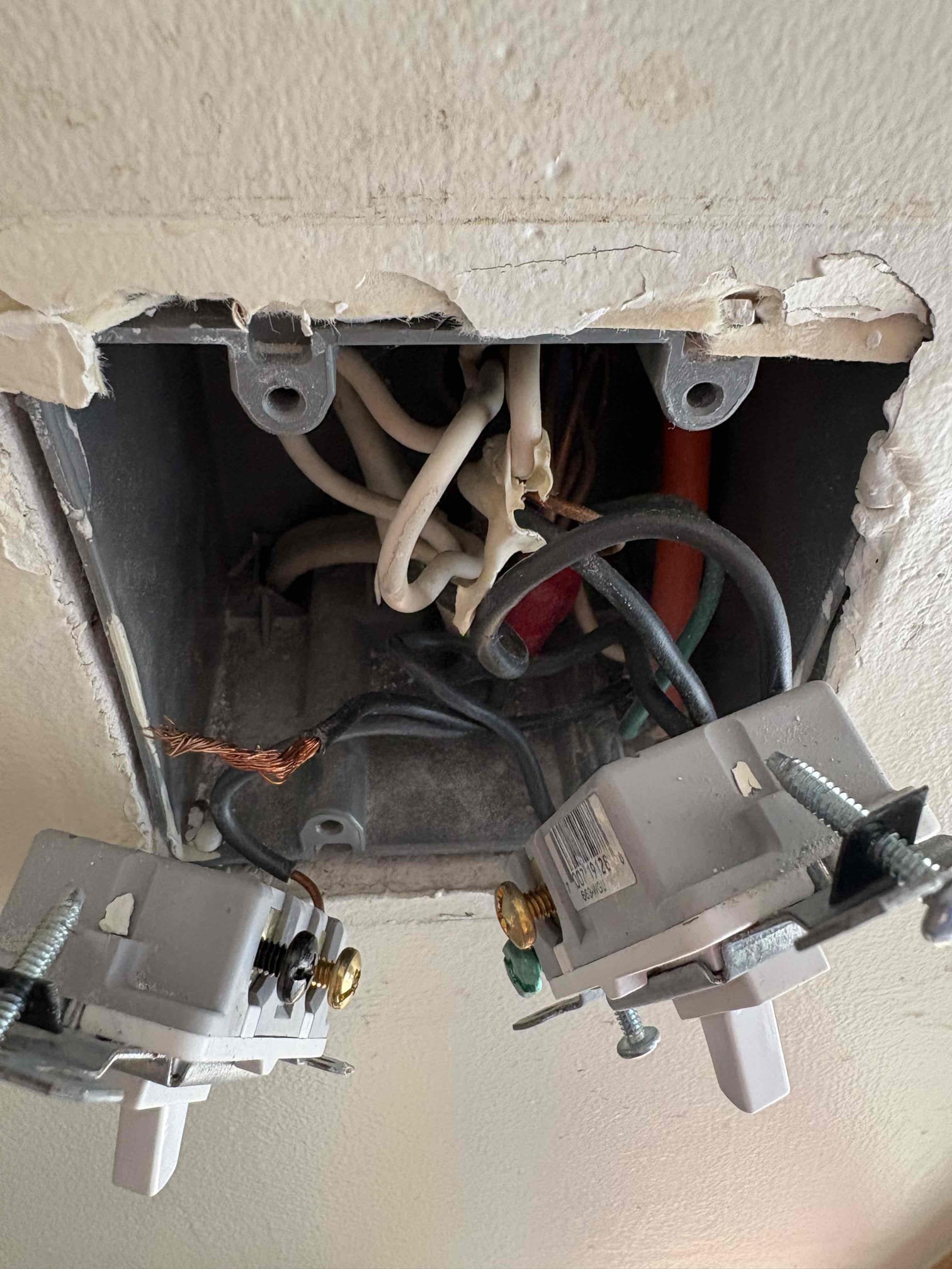 Today’s visit was for electrical corrections because of the installation of the new deck. The decking company is pulling a permit and wants the electrical wiring to be brought up to code. Under the deck there was an extension cord that went up the wall into a switch. We disconnected it from the switch and capped it in the box, and he is going to remove the wire himself. The customer still wanted switch controlled power to the exterior outlets, so we would run wire from the switch to the receptacle on the other side of the wall, by replacing the 2 gang box, and install a GFCI with a weather proof box. In our second solution we would install a weather proof metal box, GFCI, and a weather bubble cover under the deck. 