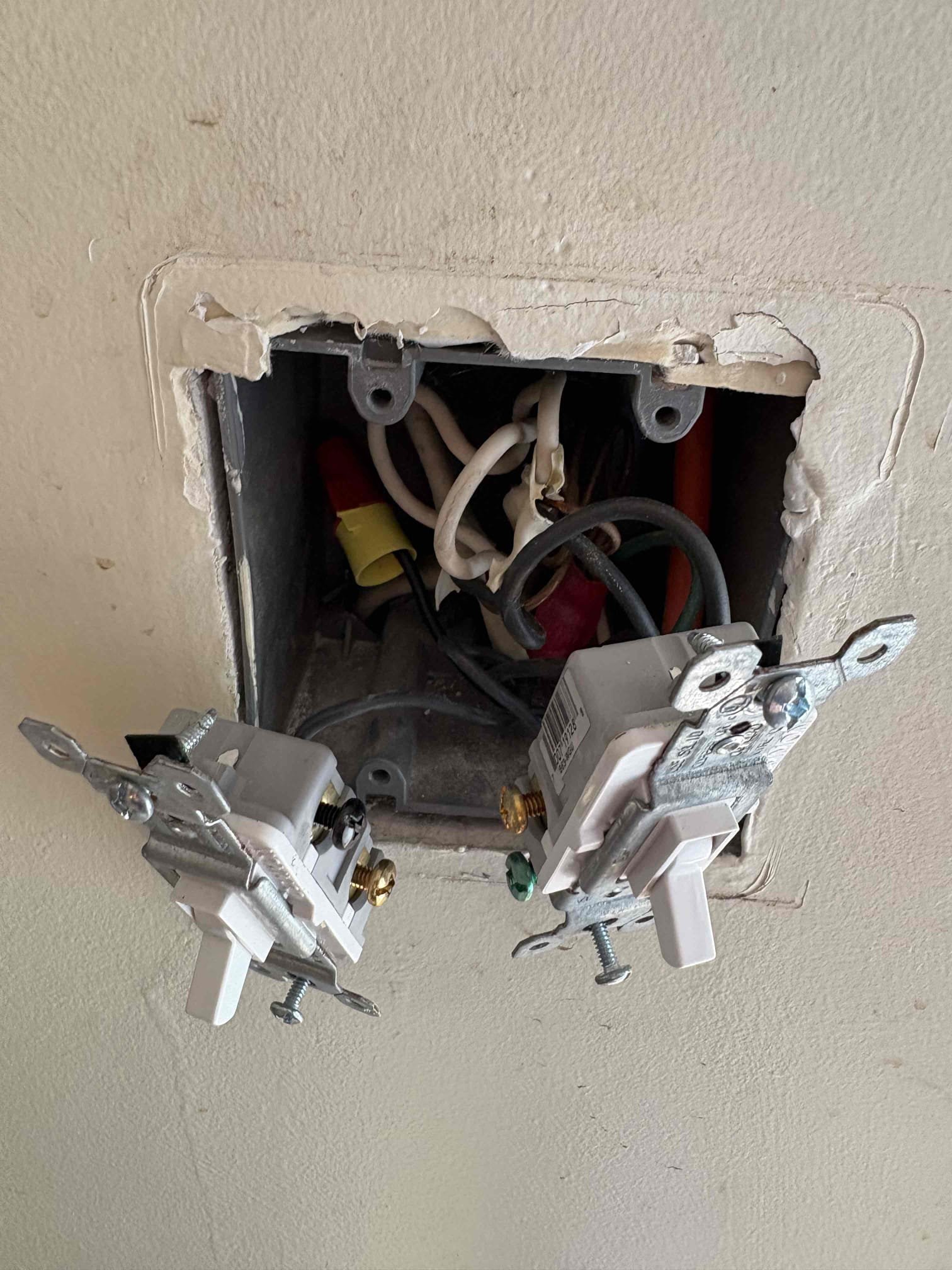 Today’s visit was for electrical corrections because of the installation of the new deck. The decking company is pulling a permit and wants the electrical wiring to be brought up to code. Under the deck there was an extension cord that went up the wall into a switch. We disconnected it from the switch and capped it in the box, and he is going to remove the wire himself. The customer still wanted switch controlled power to the exterior outlets, so we would run wire from the switch to the receptacle on the other side of the wall, by replacing the 2 gang box, and install a GFCI with a weather proof box. In our second solution we would install a weather proof metal box, GFCI, and a weather bubble cover under the deck. 