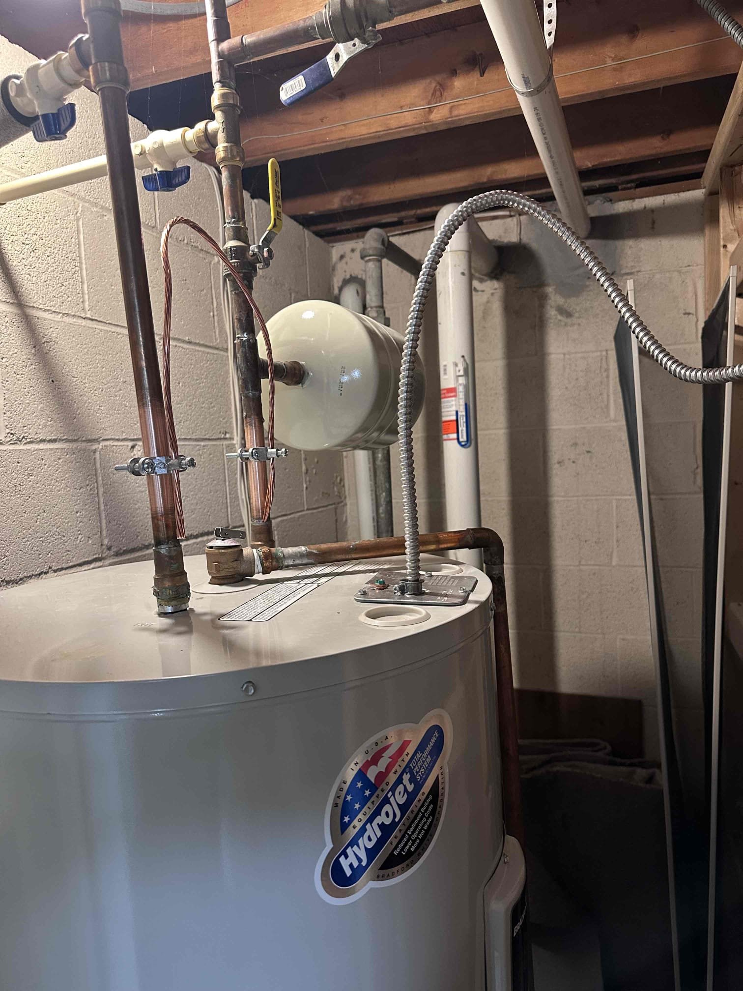 Installation of new disconnect and circuit extension for the water heater. While installing bonding for heater, saw the wires/conductors completely exposed and hanging out of jacket and connector. With water heater not being present or in eye sight of panel, we will install new disconnect for servicing and meeting current code requirements. 