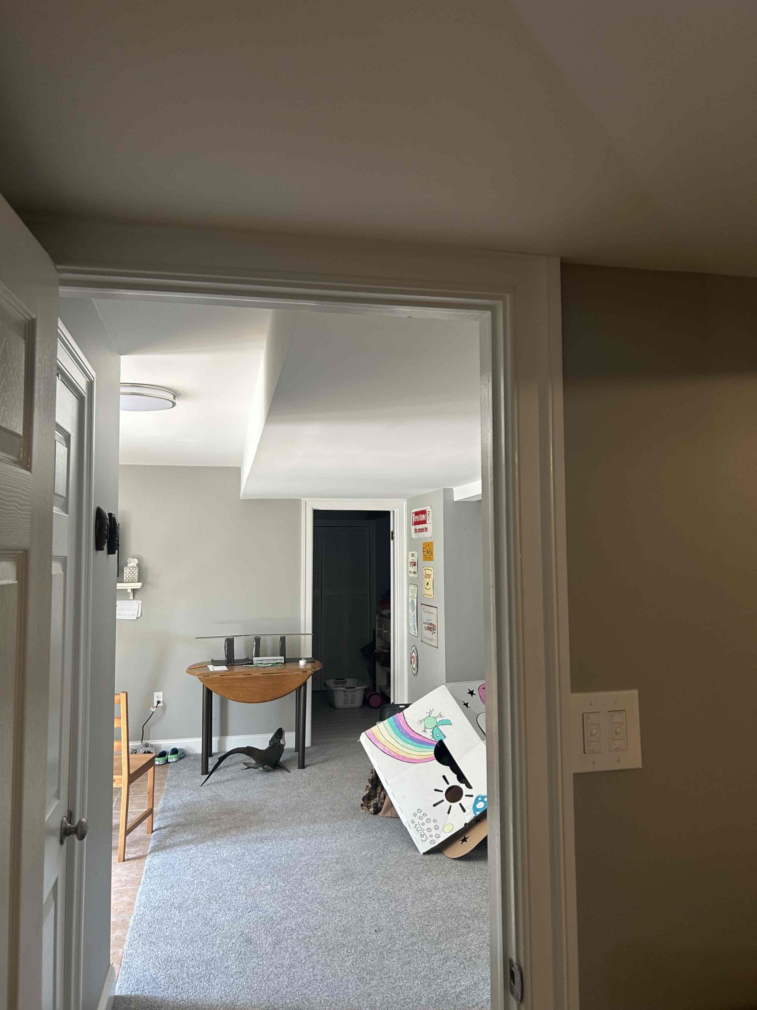 The reason for today’s visit was to look at installing a new dedicated 100 amp circuit from the main panel in the basement. Front left corner out to the garage in the back left corner of the Home. The garage itself is detached from the house so trenching will be required from the back right corner of the house out to the garage. Inside the garage we went so I knew 100 amp Q panel with grounding as well as a new dedicated 50 amp circuit out of the subpanel for a heat pump for the pool in the back of the garage. We will also need to separate the existing circuits in the garage from the house and tie them into the new subpanel
The basement in the house is mostly fully finished however, the back portion to where we will stub out underneath the deck does have an unfinished ceiling. We’ll have to run roughly 25 foot of SE cable out the back of the home and under the deck over to a junction box where we will change over to PVC.
The panel that we will be tapping out up in the house is a brand 