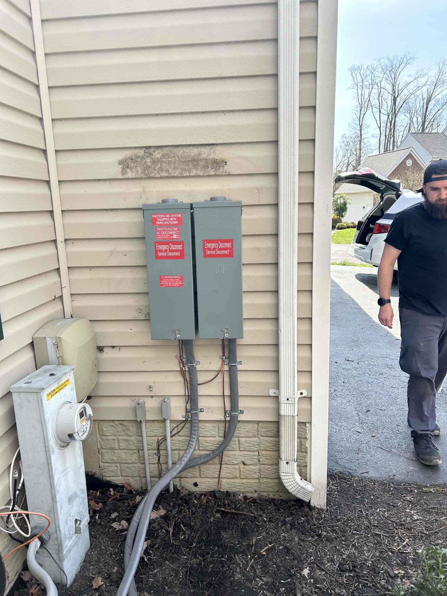 We will remove the existing 400 amp disconnect and install (2) customer supplied disconnects over the existing ports going into the trough. We will supply the PV labels to be installed on the new disconnects. We will bring out some scrap 4/0 alum wire in the event any of the conductors needs to be replaced due to being too short. Power will be out while this work is being performed. 

The stickers are on order. I will reach out once received to schedule the work. 

Once completed, we can call back in for inspection. 
Remove dangling devices hanging in the garage and surface mount two new GFCI to the wall in their place.