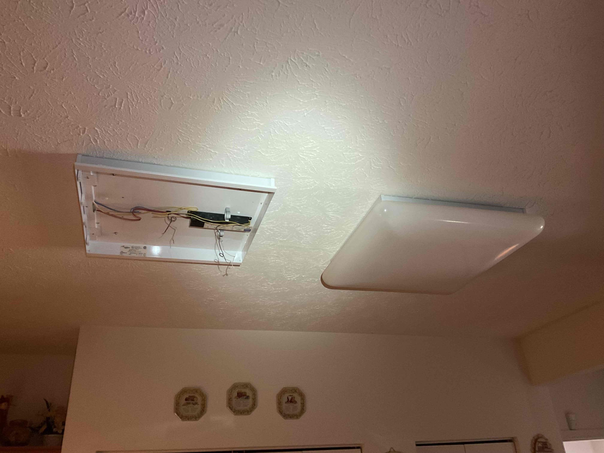 Today's visit was to take a look at installing two new LED Flat-Panel lights in the kitchen in place of two original fluorescent fixtures. When I arrived, I took down the light cover to determine which circuit was linked to the lighting, and found that the location for the fixture boxes were not conducive to the requested layout of the new (more rectangular) fixtures and the circuit would need to be extended to those new locations. I also noticed that the smoke detectors in the home were older/missing/had no batteries. I offered to provide a solution to install new units and Ms. Arlene let me know that they had two new hardwired/interconnected Smoke/CO detectors that I could use. My solution(s) today included installing the two new kitchen light fixtures, changing a 3-way switch to control said lights with a dimmer, and to replace the customer-supplied detectors. I started by changing the detectors, and re-wired with new splices at both locations due to paint covering the splices. I mo