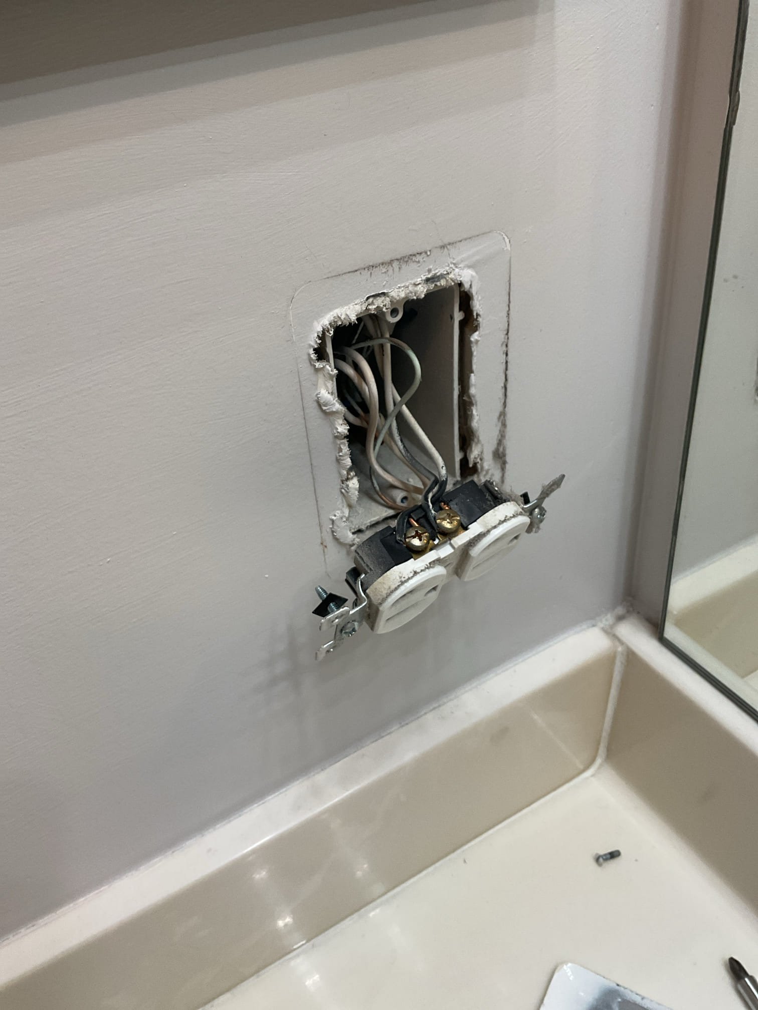 Today’s visit was to take a look at some receptacles that the homeowner described as “popping” in the dining area and the bathroom. When I arrived, I started by opening up the affected receptacles in the dining area, which I noticed were a part of the condo’s kitchen circuit. The receptacles were originally installed using improper terminations (Wires oriented the opposite way under the screw terminals/insulation left under screw terminals) and were causing arcing due to those loose connections. This most certainly can cause the popping sound heard, and the bathroom receptacle was also installed in a similarly hazardous fashion. We also checked the microwave receptacle which was installed properly, Ms. Susan wanted to ensure it could support a new microwave and it is in great shape to do so. I went throughout the home and opened up a few other devices to check if there were other devices installed in the same manner and found backstabbed/loose connections throughout the home. I also to