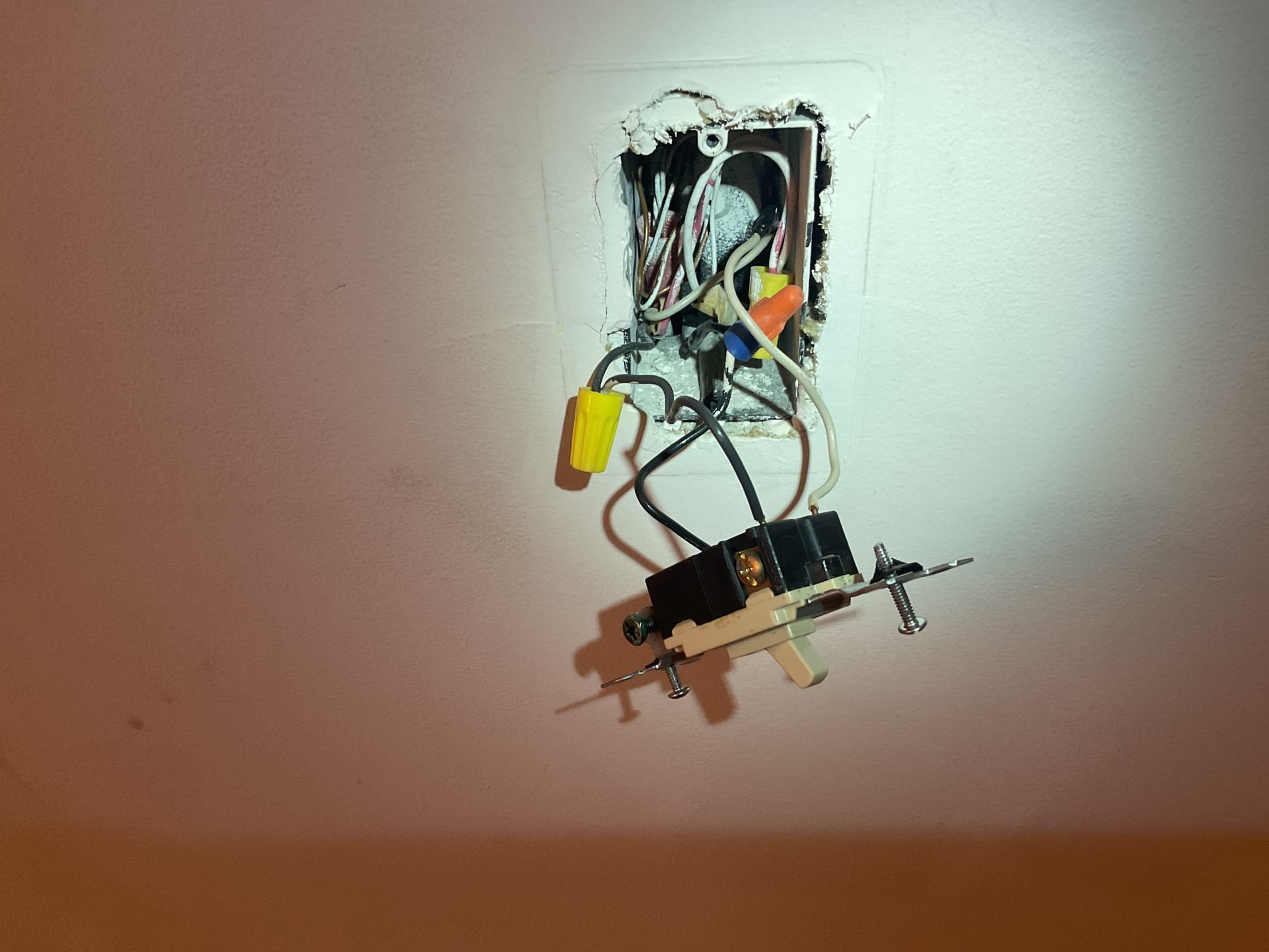 The reason for today’s visit was to take a look at a stairwell light fixture that was not working properly. When I arrived, I met with Ms. Connie who showed me the switches that controlled the basement stairwell light. I started the troubleshoot by opening up the two 3-way switches that controlled the light going down to the basement. I noticed that the switches looked relatively original to the home (1998) and were wired using the backstab method, which can cause device failure faster than using the device screws. One of the 3-way switches was starting to crack apart and was failing due to age/heat damage. Once I bypassed the switch, the light started working again. I also took a look at a switchbank in the master bedroom that she was having issues with after installing a new Decora-style dimmer herself. There were several switches in that switchbank that were backstabbed as well and seemed to be in poor condition, so I offered to not only replace those as well, but to also go around 