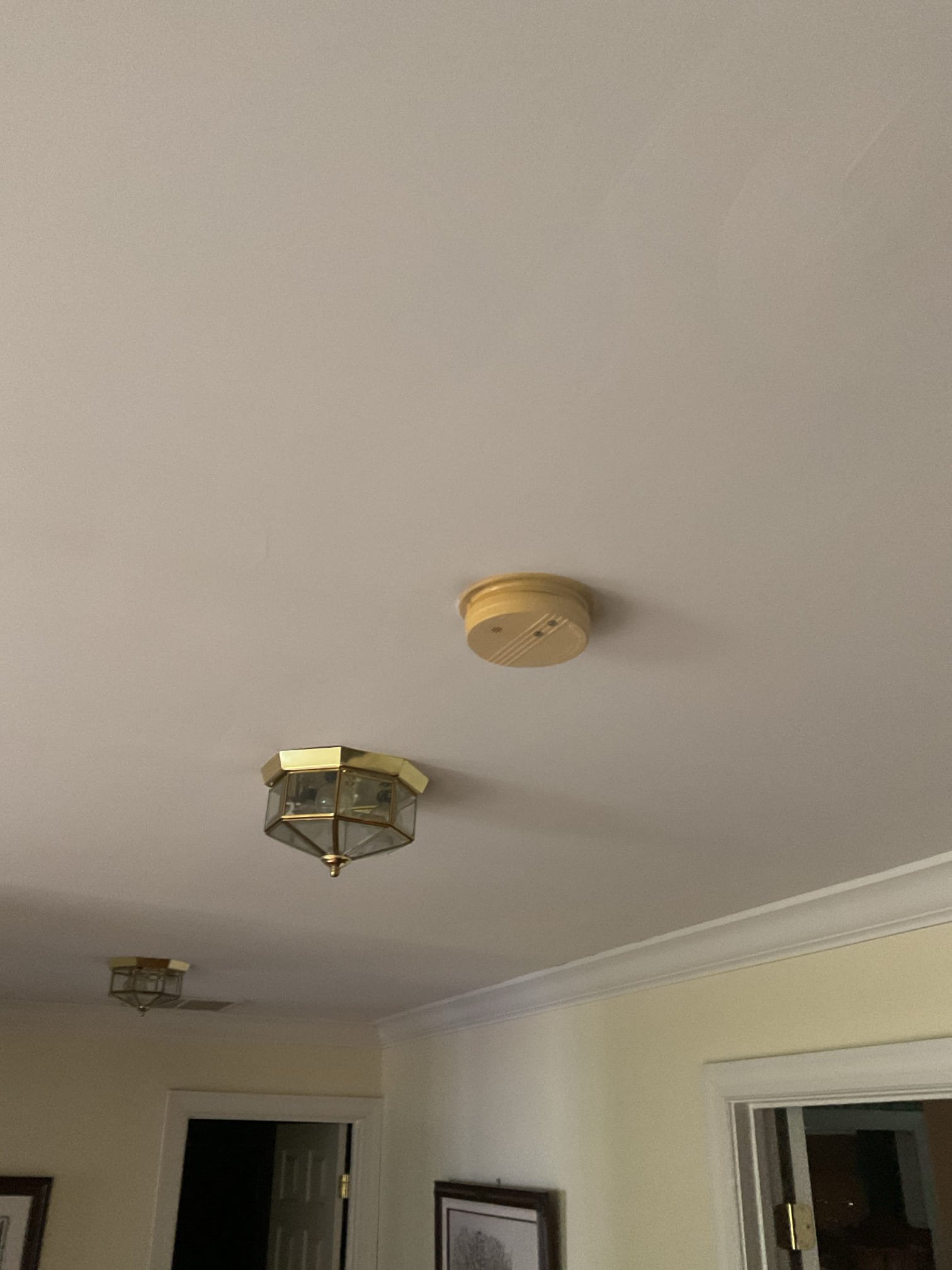 Today’s visit was to take a look at replacing some exterior light fixtures & loose receptacles. When I arrived, I met with Ms. Cathy who showed me the fixtures that needed swapping on the exterior of the home (Two outside front door, a post light, one above the garage, one on the side of the garage, and one in the rear of the home above the sliding door). She also showed me which three exact receptacles she wanted replaced as they had come loose due to being heavily used for vacuuming over the years (Two on kitchen island and one on barrier wall next to table). While I was conducting my performance & safety assessment, I opened the main panels and found a few hazards including shared neutral/multi-wire branch circuits, a lack of whole-home surge protection, and double tapped grounds & neutrals. I also noticed a lack of GFCI protection for the sump pump receptacle, a missing bonding jumper at the water heater, and expired smoke/CO detectors throughout the home. I brought these concerns 