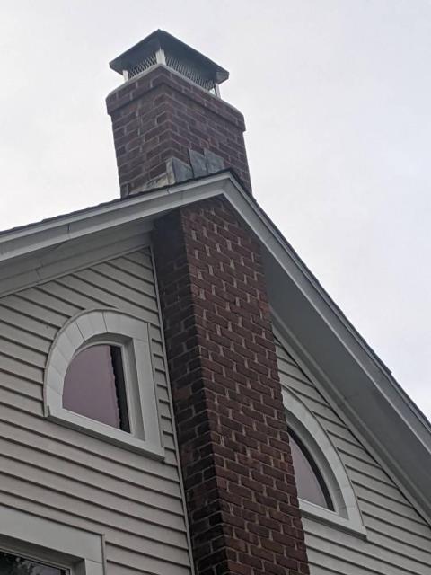 Chimney had loose and missing mortar with open gaps between brick.  Rebuilt chimney from roofline up.   