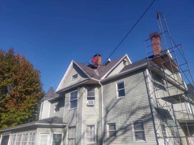 VICTORIAN HOME BUILT IN 1895 2 FAMILY HOME in New Haven-  installed heating liner systems for these unlined chimneys.   High pitched roofs , full staging set ups were needed