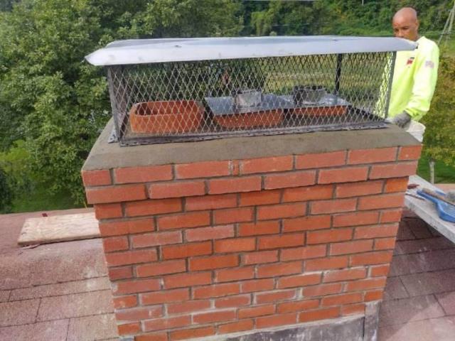 Rebuilt and relined deteriorated and uncovered multi-flue chimney.  Connected a stainless steel liner system to safely vent the woodstove that is used as secondary heat in the home 