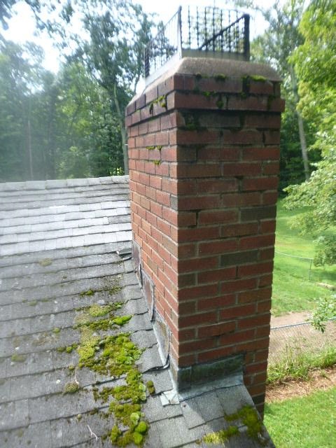 Moss damaged Tolland ct chimney rebuilt from roof up , new shingles , flashing and brick and mortar and cap