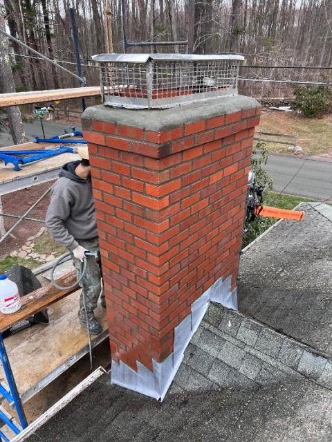 This chimney was missing part of the crown and didn't have any caps on the flues. The top two flue tiles needed to be replaced, also. Safeside Chimney performed a roof-up rebuild, replaced the top two flue tiles, and did the flashing.