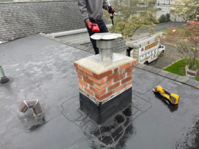 Uncapped chimney has taken on years of water entry, damage on interior and exterior- Installed a chimney liner and did a partial rebuild up to the existing rubber roofing 