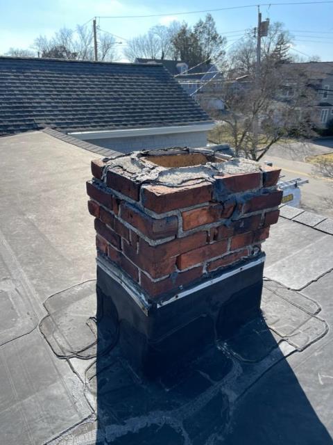 Uncapped chimney has taken on years of water entry, damage on interior and exterior- Installed a chimney liner and did a partial rebuild up to the existing rubber roofing  Uncapped chimney has taken on years of water entry, damage on interior and exterior- Installed a chimney liner and did a partial rebuild up to the existing rubber roofing