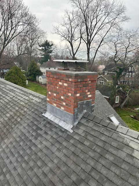 This chimney was showing signs of wear and needed flashing and a crown. Safeside Chimney performed a roof-up rebuild, installed new flashing, and put a new crown and caps.