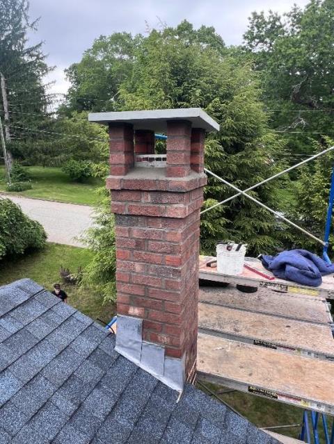 Previously repaired chimney in Windham, CT had areas of original construction show signs of water entry. Performed a roof up rebuild with all new brick and mortar. 