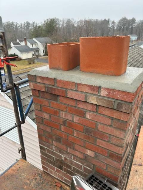 Severely deteriorated South Windsor Ct chimney, with cracks through the top rows and separated loose mortar. Did partial rebuild, and reinstalled the existing caps.