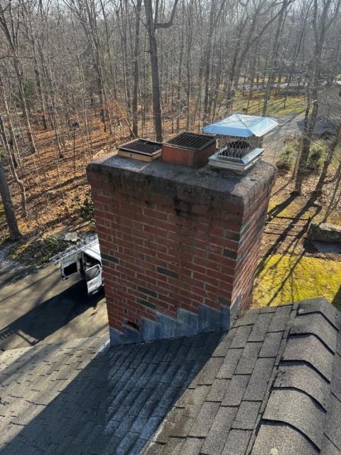 Chimney in Old Lyme CT , we found exterior of this chimney has been subject to several years of water entry, penetration and saturation activities. We rebuilt a portion of the exterior with new brick and mortar, installed new flashing, poured a new crown, and a new chimney cap.