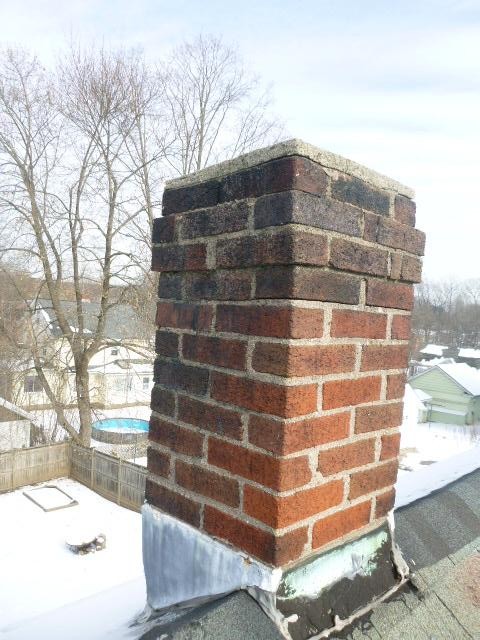 Took a look at this chimney in Enfield CT and found that the Top of the Chimney Had Sulfuric Acid and Structural Damages Developing Down to the Roofline. Performed a roof up rebuild, including flashing, cap, and crown.