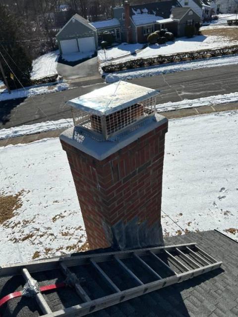 Need To Setup Around the Top of the Chimney in Windsor CT, Cut Down Top Flue Tiles In Order To Accept A Proper Cap, Then Re-mortar The Entire Top Cement Crown With a Waterproof Cement To Properly Shed Water Thus Keeping the Lower Masonry Structure Protected.