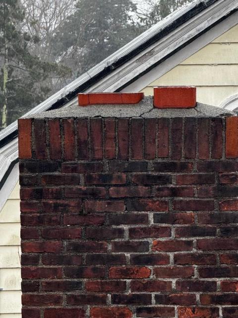 Older water stained and deteriorated New Haven Ct chimney that vented both the oil and fireplace flues. Had past issue with birds. Rebuilt chimney and installed animal guard chimney cap.