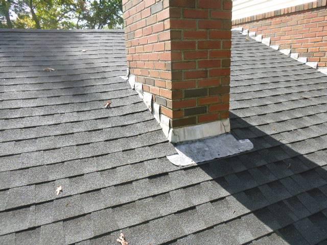 In Ellington, CT, the original chimney counter flashing is failing, allowing water entry, which has caused ceiling staining above the wood stove. Replacing the flashing with new lead, properly tucked and cemented in place with a waterproof cement, will prevent further water damage to the roof, walls, and ceilings.