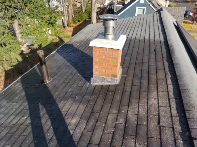 This chimney in Bristol CT had moss growth, loose bricks, and missing mortar. Safeside Chimney did a roof up rebuild to restore the chimney to its original condition.
