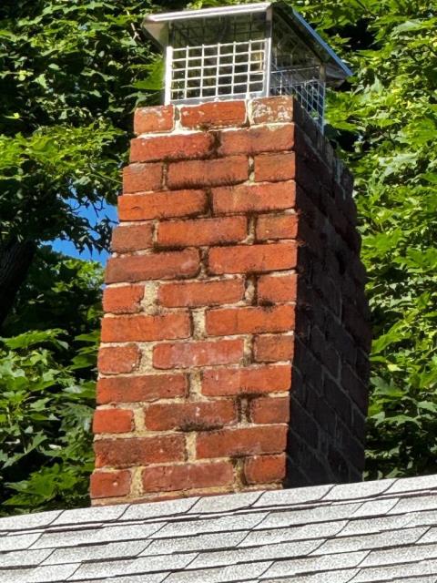 This chimney in Putnam, CT, had loose bricks and missing mortar, and sustained damages to the chimney from the outside. We rebuilt this one from the roof up, including new flashing, cap, and crown.