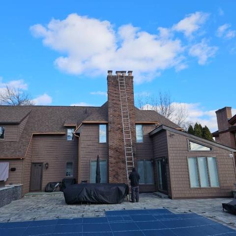 This large chimney, in Wethersfield, CT, was missing its chimney caps.  Installed new stainless steel rain caps. 