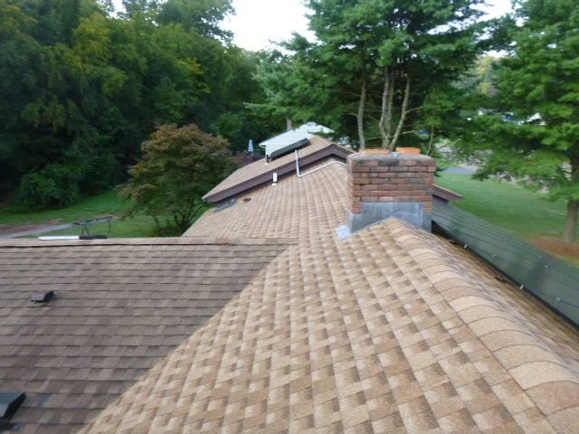 Roof up chimney rebuild in Branford CT. New crown, flashing, and multi flue cap.