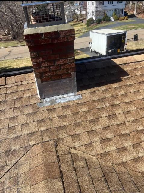 Roof up chimney rebuild in Branford CT. New crown, flashing, and multi flue cap.