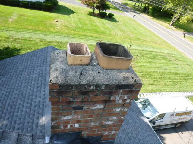 This chimney in Bloomfield had a cracked crown and no caps. Needed to install crown coat weather proof coating and two stainless steel caps to prevent water entry.