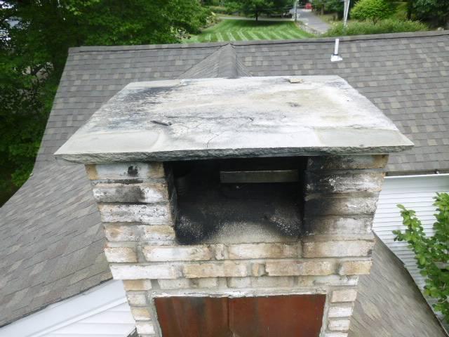Westport CT slate chimney cap replacement – The homeowner’s slate cap had visible cracks, so we replaced it with a brand-new custom cut bluestone cover for durability and protection.