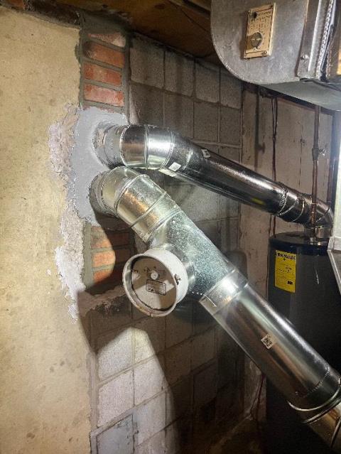 In Hamden, CT, installed a stainless steel 2-ply smooth wall chimney liner system to safely vent two high-efficiency oil burners that were causing acidic damage inside a cold chimney structure.