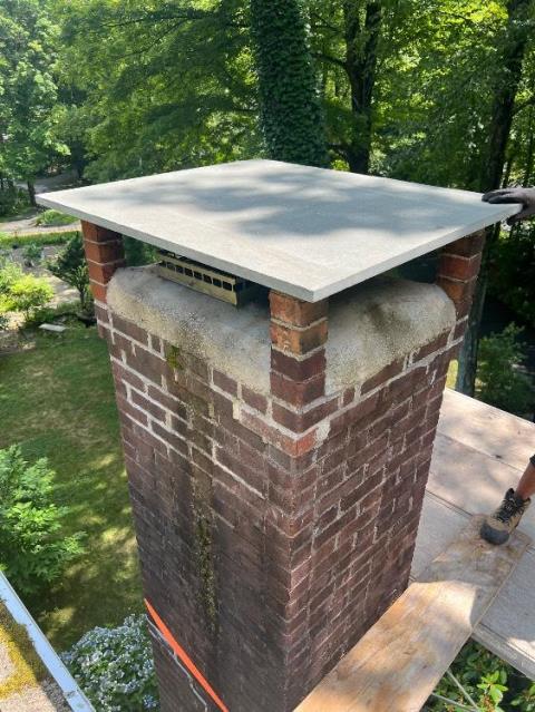 Upon arrival in Bloomfield, CT, we found the slate cap was too small and concave. Water runoff was rolling down the inside flue opening. We replaced that with a new bluestone cap.