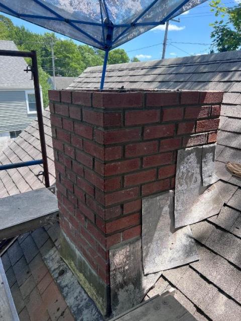 Rebuilding in progress , to resolve water damaged chimney in Wallingford Ct with new lead flashing.