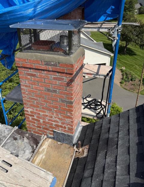 Safeside Chimney removed the chimney to the roofline, rebuilt it with new brick, cement, flashing, crown, and bluestone shoulder shelf, then reinstalled the homeowner’s stainless steel cap.