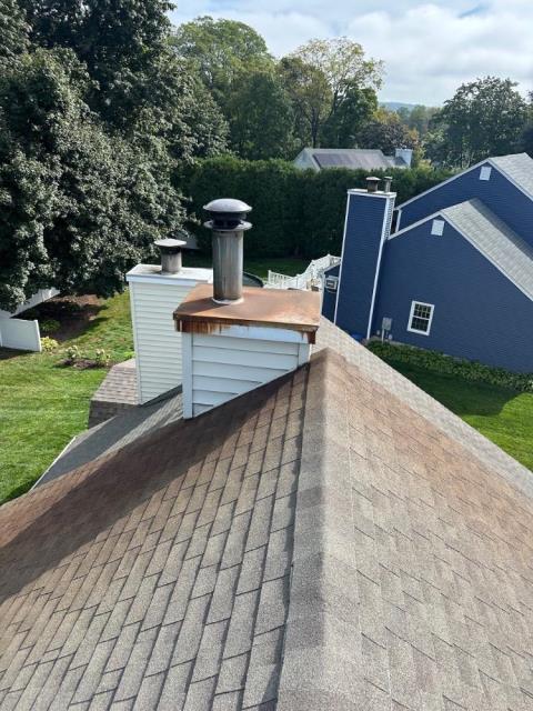 Rusty Portland Ct chase pan replaced – the original galvanized metal flat pan allowed water to pool, cause rust, and come in around chimney pipe – New stainless steel chase cover installed with proper angled breaks to allow water to run off, rather than pool, as well as a storm collar to keep damaging water from entering the chimney chase and home.
