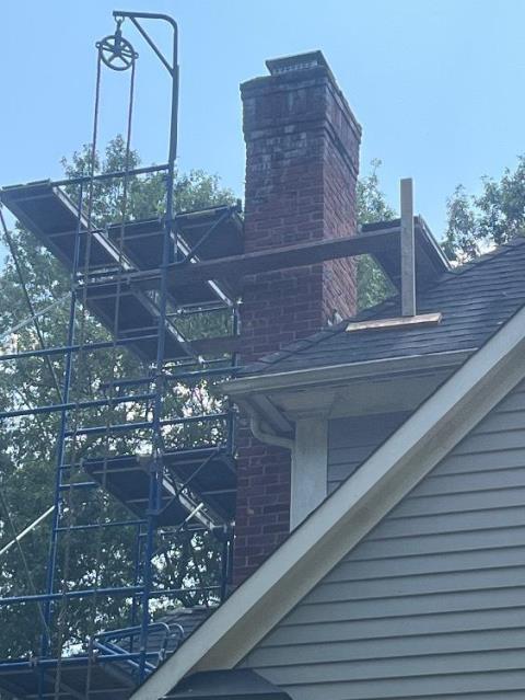 In Avon, CT, the top of the chimney is severely damaged, with loose bricks, cracked crown, failing flashing, and water entry causing structural deterioration and effloressence staining.  To prevent further damage, the entire top section must be rebuilt with new materials and proper flashing.